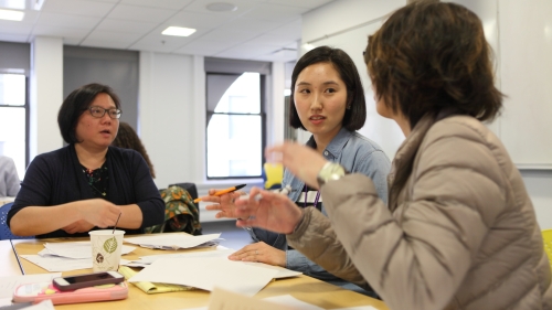 Two students and their professor in a discussion