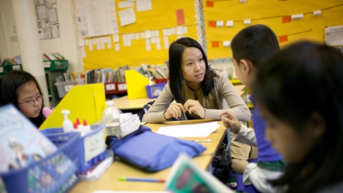 teacher working with students