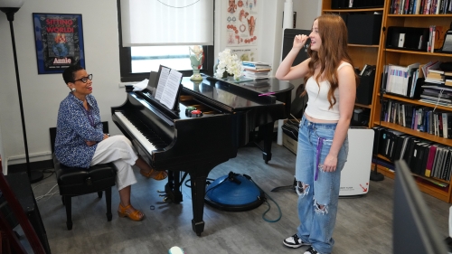 NYU professor working with classical voice student at piano