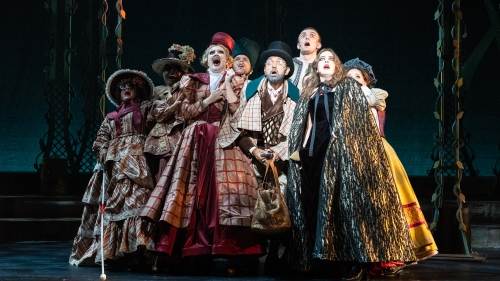 Large ensemble on stage looking fearful during performance