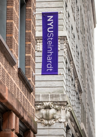 The NYU Steinhardt flag on the outside of a building