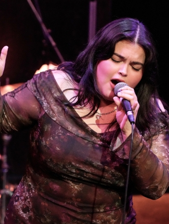 Soloist on stage singing into microphone